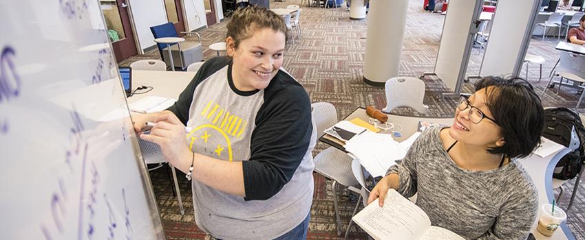 Students working together at a table in the Marx library