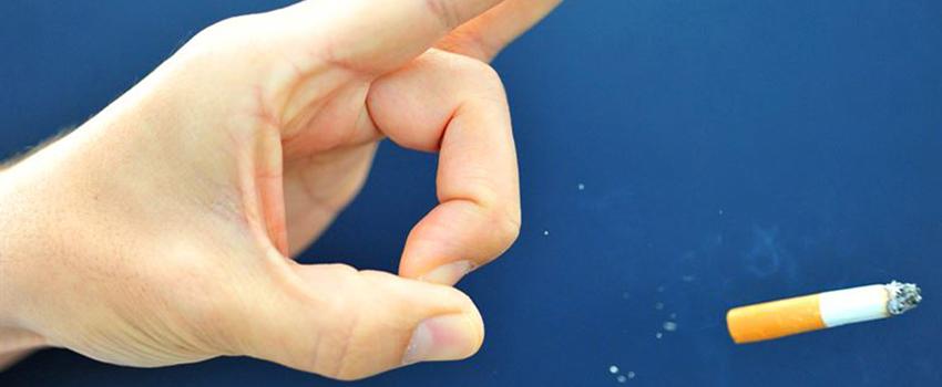 Hand flicking a cigarette 